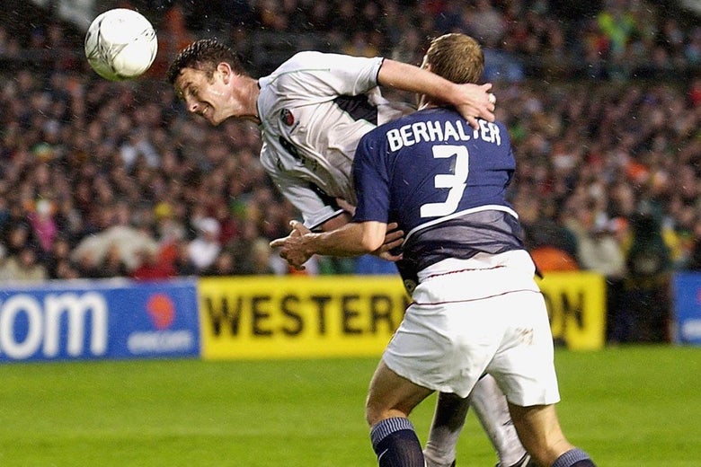 Mark Kinsella of Ireland is challenged by Gregg Berhalter of the USA.